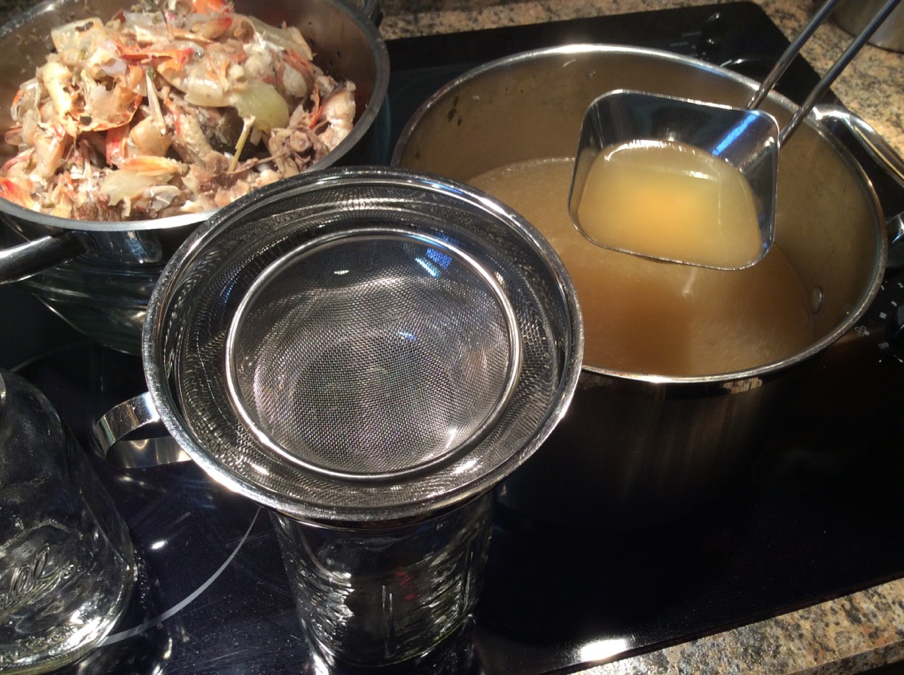 Ladle Hot Broth Through Strainer into Jars